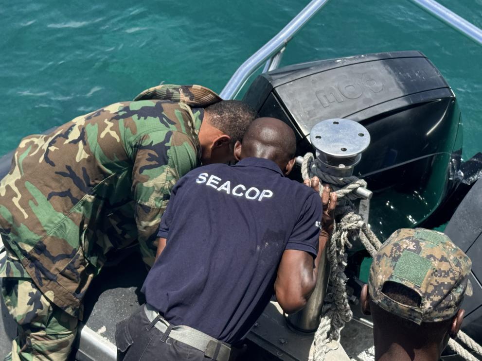 Maritime security checking a boat at sea.